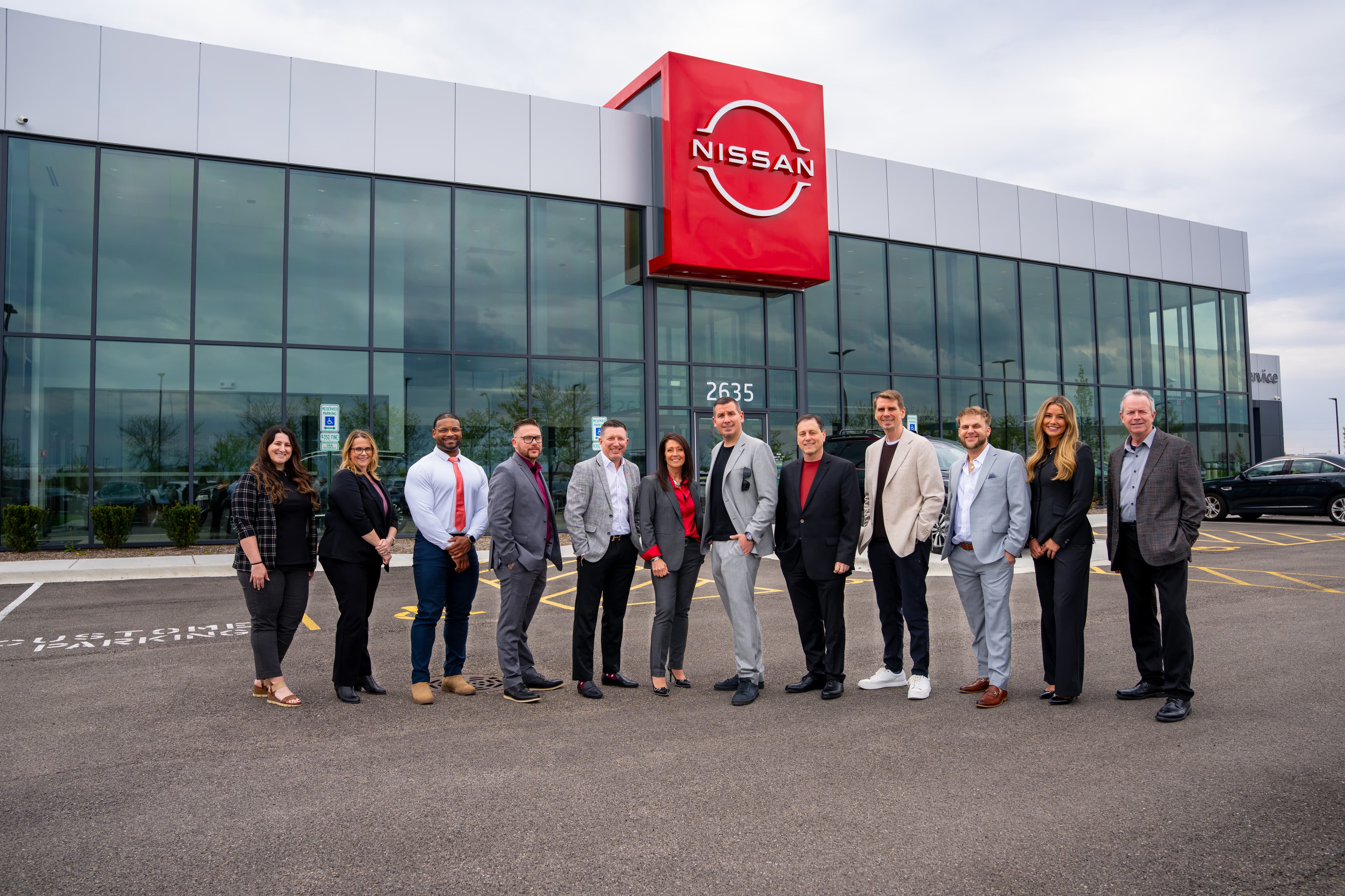 The Coleman Prime team in front of Nissan of Elgin on closing day